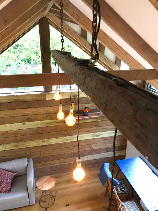 Rustic hanging light in log cabin.